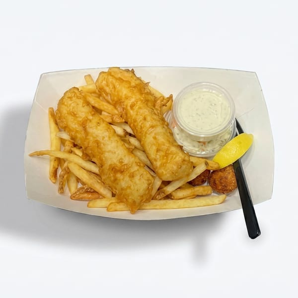 Two pieces of golden-brown fish and chips with tartar sauce, hushpuppies, and a lemon wedge.